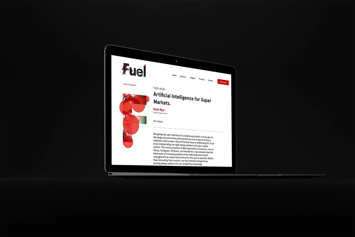 Fuel festival article page displayed on a laptop against a dark background, with red graphics and an artificial intelligence article.