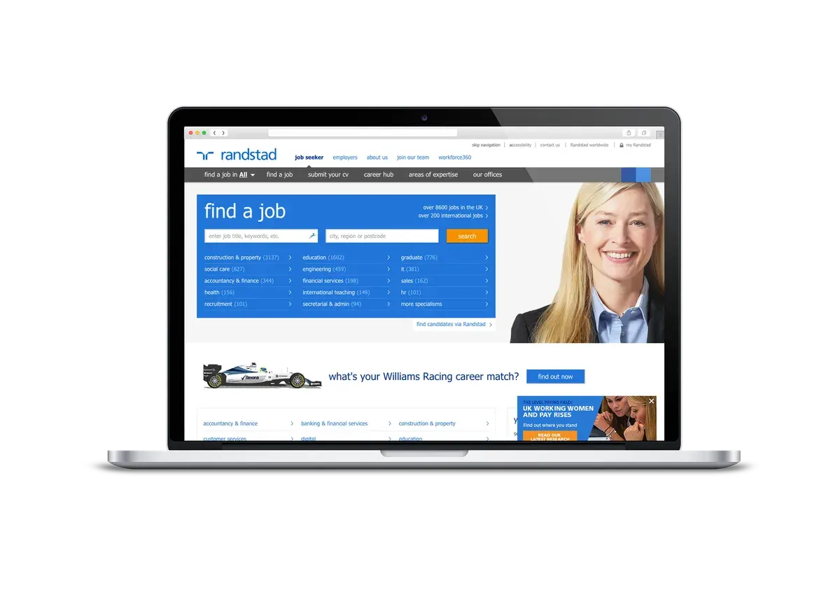 Randstad desktop job-search website displayed on a laptop with a blue search panel and recruitment content.